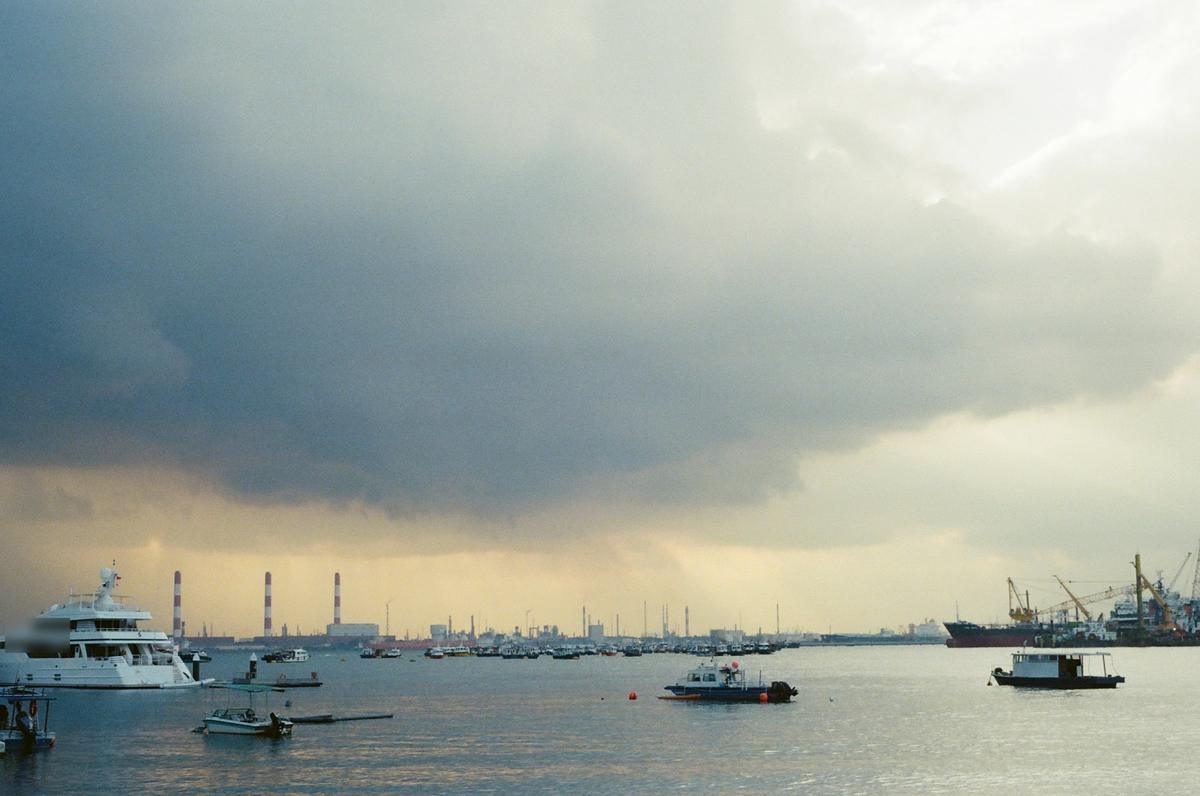 Storm clouds over yachts and boats at anchor off Singapore